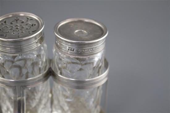 A George III silver oval ink bottle stand, London, 1799 (no makers mark), with three later Victorian silver monted glass bottles